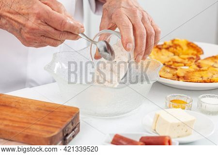 Senior Woman Preparing A Traditional Dish From El Valle Del Cauca In Colombia Called Aborrajado