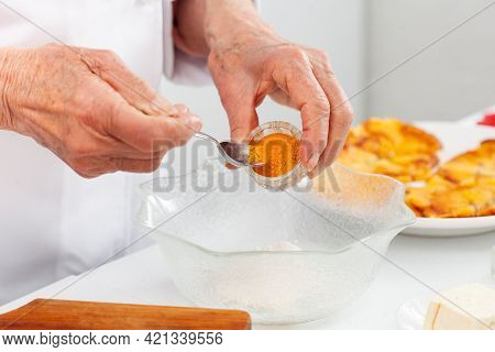 Senior Woman Preparing A Traditional Dish From El Valle Del Cauca In Colombia Called Aborrajado