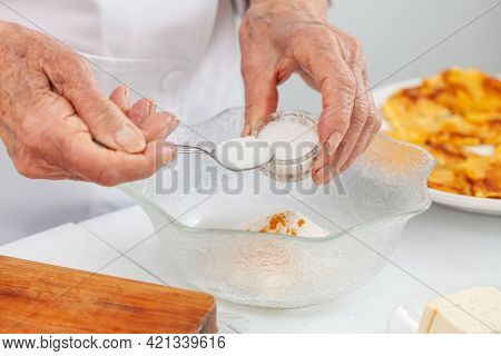 Senior Woman Preparing A Traditional Dish From El Valle Del Cauca In Colombia Called Aborrajado