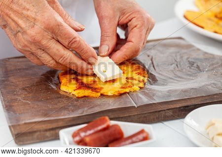 Senior Woman Preparing A Traditional Dish From El Valle Del Cauca In Colombia Called Aborrajado