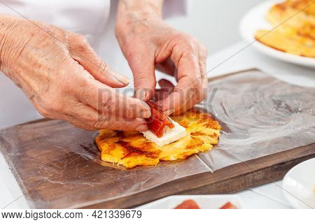Senior Woman Preparing A Traditional Dish From El Valle Del Cauca In Colombia Called Aborrajado