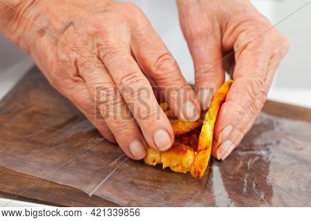 Senior Woman Preparing A Traditional Dish From El Valle Del Cauca In Colombia Called Aborrajado