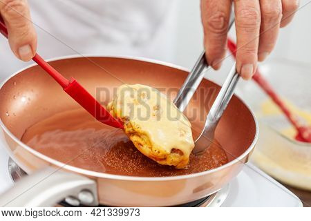 Senior Woman Preparing A Traditional Dish From El Valle Del Cauca In Colombia Called Aborrajado