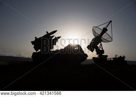 Creative Artwork Decoration. Silhouette Of Mobile Air Defence Truck With Radar Antenna During Sunset
