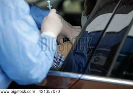 Details With People Getting Covid-19 Vaccines In Their Arms Right In Their Cars, In A Drive Thru Vac