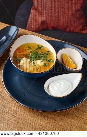 Russian Homemade Chicken Noodle Soup With Dill In A White Plate On A Table In A Restaurant