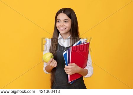 Happy Girl Child Back To School Holding Apple And Books Yellow Background, Knowledge Day