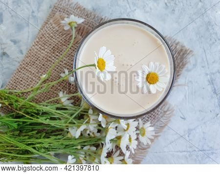 Glass Of Milk Drink, Chamomile Flower On A Concrete Background, Fermented