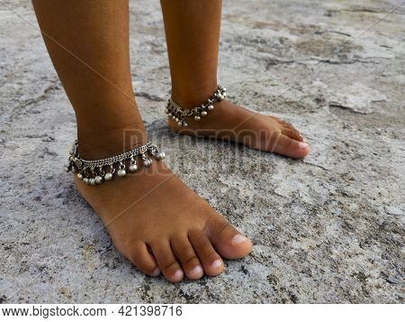 A Close Shot Of Anklet Chain Legs Isolated On Rough Background, Kalaburagi, Karnataka, India-may 19.