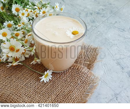 Glass Of Milk Drink, Chamomile Flower On A Concrete Background, Fermented