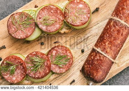 Salami Sausage Stick And Rye Bread Sandwiches With Smoked Sausage And Vegetables On Cutting Board, H
