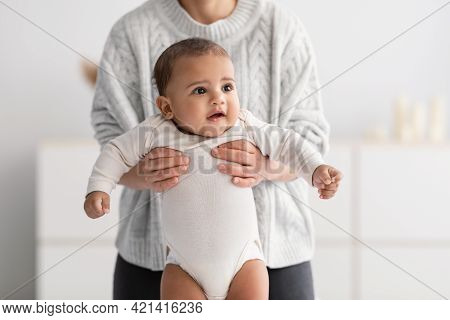 Young Babysitter Nanny Playing With Adorable Black Infant