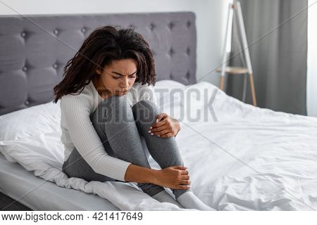 Depressed Black Lady Sitting On Bed Alone And Feeeling Upset