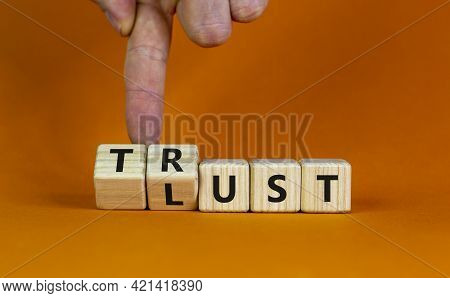 Lust Or Trust Symbol. Businessman Turns Wooden Cubes And Changes The Words 'lust' To 'trust'. Beauti