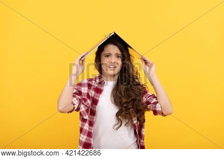 Unhappy School Girl Worry Holding Laptop Computer On Head For Distance Education, Telelearning