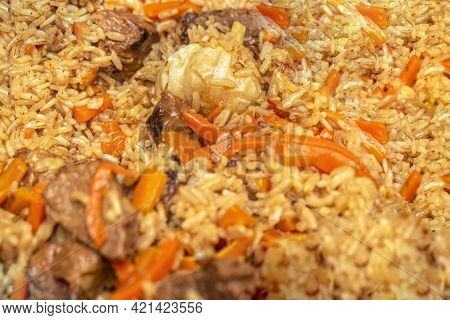 Pilaf Close-up. Oriental Cuisine Concept. National Uzbek Pilaf With Meat In A Cast-iron Pan. Top Vie