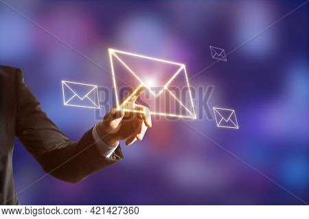 Hand Touhing An Orange Letter Icon With Blurry Background. Mailbox And Social Communication Concept