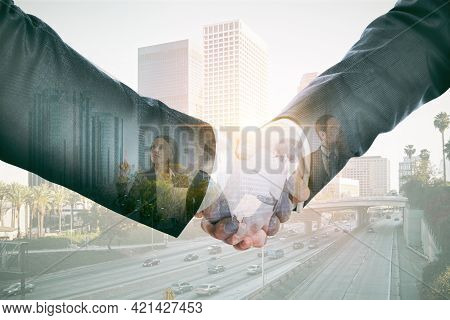 Businessmen Shaking Hands Closeup With City View In The Background, Partnership And Cooperation Conc