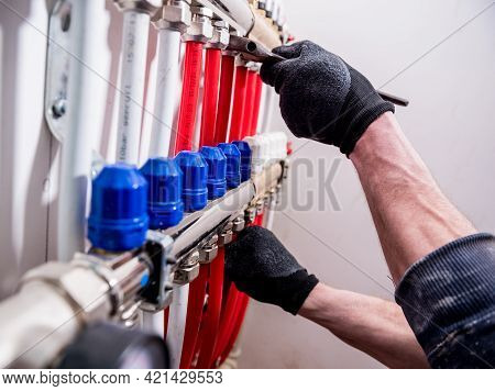 Pipefitter Install System Of Underfloor Heating System At Home