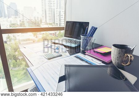 Office Laptop Business Financial Document Chart And Graph On Wooden Table With Coffee Cup. Flat Lay 