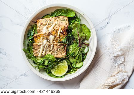 Fried Tofu With Green Salad And Nut Dressing In A White Bowl. Asian Cuisine, Vegan Food Concept.