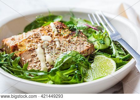 Chunks Of Fried Tofu With Green Salad In A White Bowl. Asian Cuisine, Vegan Food Concept.