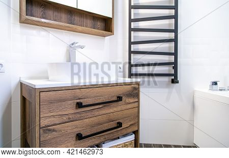 Light Bathroom Interior With Wooden Furniture In A Minimalist Style.