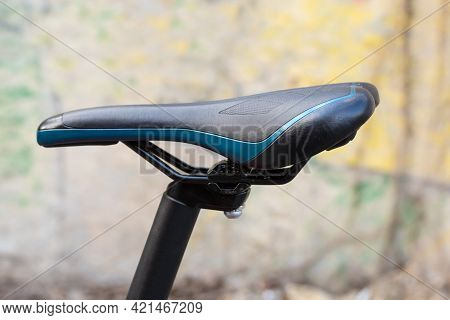 Leatherette Saddle And Top Part Of Seat Post Of Modern Bicycle On A Blurred Background, Side View Cl