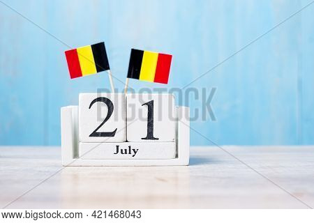 Wooden Calendar Of July 21th With Miniature Belgium Flags. Belgian National Day And Happy Celebratio