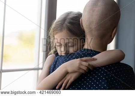 Sad Serious Daughter Girl Hugging Hairless Mom With Cancer