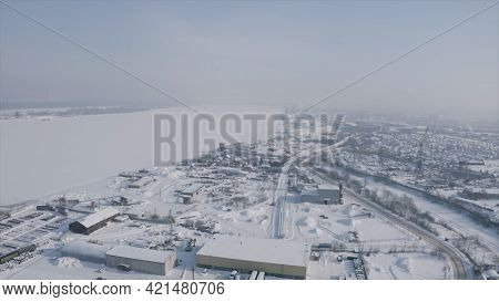 A Suburb, Village Or Industrial Quarter Of A Winter City. Clip. Aerial View Of A Town Located By The