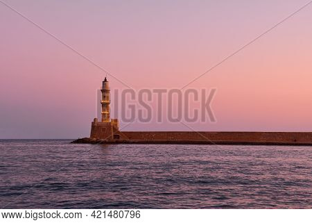 Old Lighthouse Of Xania In Red Dawn And Calm Mediterranean Sea