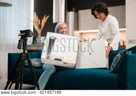 Happy Videobloggers Record Unpacking Video For Their Video Blog With A Brand New Gaming Console At H