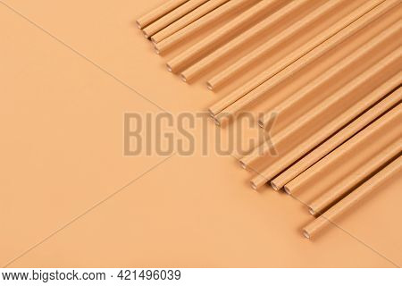 Close Up View Of Eco-friendly Paper Drinking Straws On Light Brown Paper Background With Copy Space.