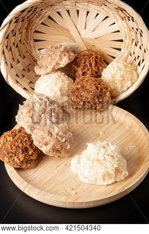 Cocada, Coconut Candy From Brazil, White And Brown Cocadas On Round Wood Fallen From A Straw Basket,
