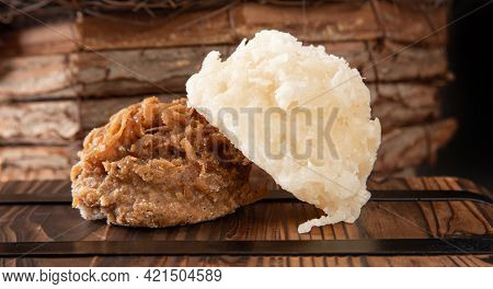 Cocada, Coconut Candy From Brazil, White And Brown Cocadas In Close Up On A Rustic Wooden Surface An