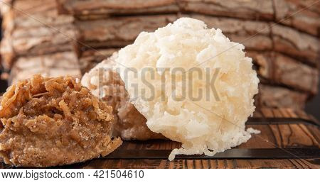 Cocada, Coconut Candy From Brazil, White And Brown Cocadas In Close Up On A Rustic Wooden Surface An