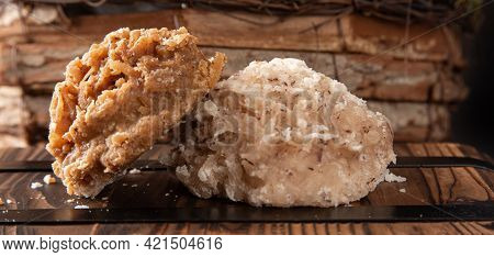 Cocada, Coconut Candy From Brazil, White And Brown Cocadas In Close Up On A Rustic Wooden Surface An