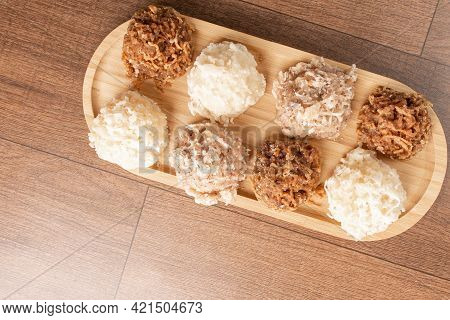 Cocada, Coconut Candy From Brazil, White And Brown Cocadas On Wooden Surface, Black Background, Top