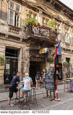 Budapest, Hungary - April 25, 2019: Unidentified people hang out at the entrance to Szimpla Garden ruin club in Budapest. Famous modern underground bars in Budapest