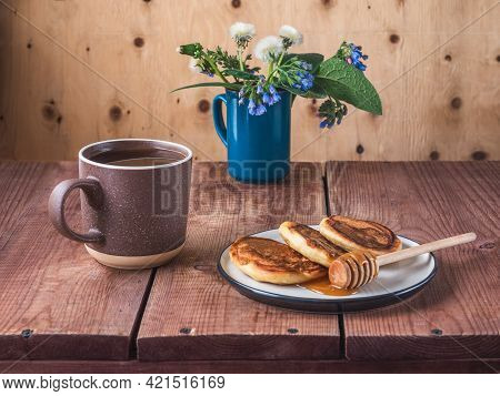 Pancakes With Honey And Spring Bouquet In A Blue Mug, Dandelions And Blue Symphytum Caucasicum