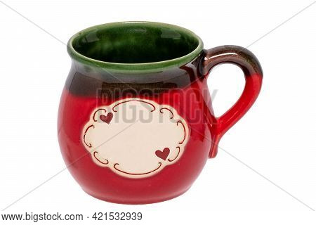 Close-up Of A Red Green Ceramic Cup With An Empty White Label And Two Little Hearts On It Isolated O