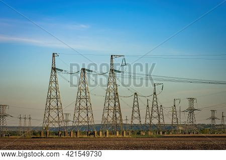 High Voltage Power Line On Industrial Electricity Line Tower For Electrification Rural Countryside. 
