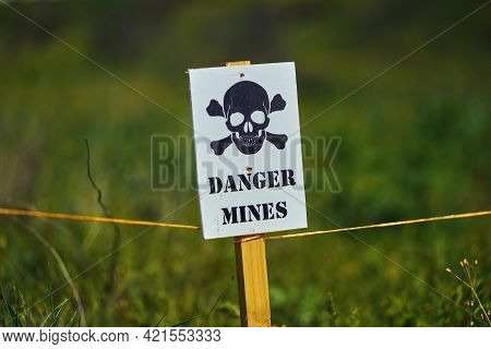 A Sign With A Skull Warning Of Danger In A Minefield