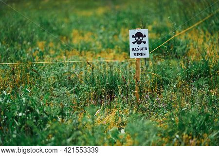 A Sign With A Skull Warning Of Danger In A Minefield