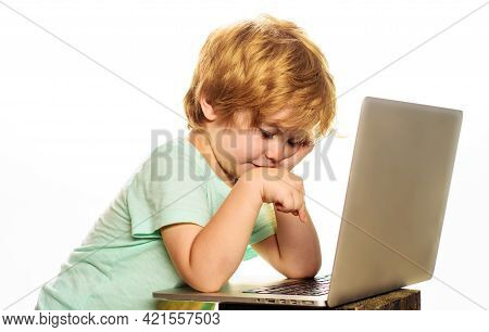 Little Boy With Computer. Child Studying Or Playing Game With Laptop. Education, Learning And Techno