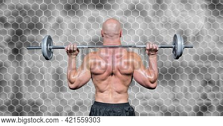 Composition of rear view of muscular man lifting weights with hexagons on grey background. sport, fitness and active lifestyle concept digitally generated image.