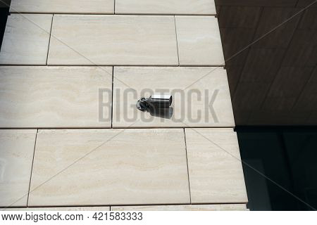 Photo Of A Security Camera Located On An Office Building Filming An Outside View