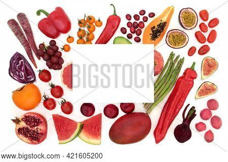 Healthy food high in lycopene for good health with a collection of fruit and vegetables with white card . High also in antioxidants, dietary fibre, anthocyanins, minerals and vitamins. Copy space.