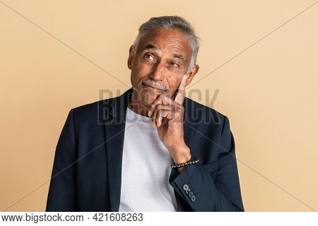 Thoughtful mixed Indian senior man